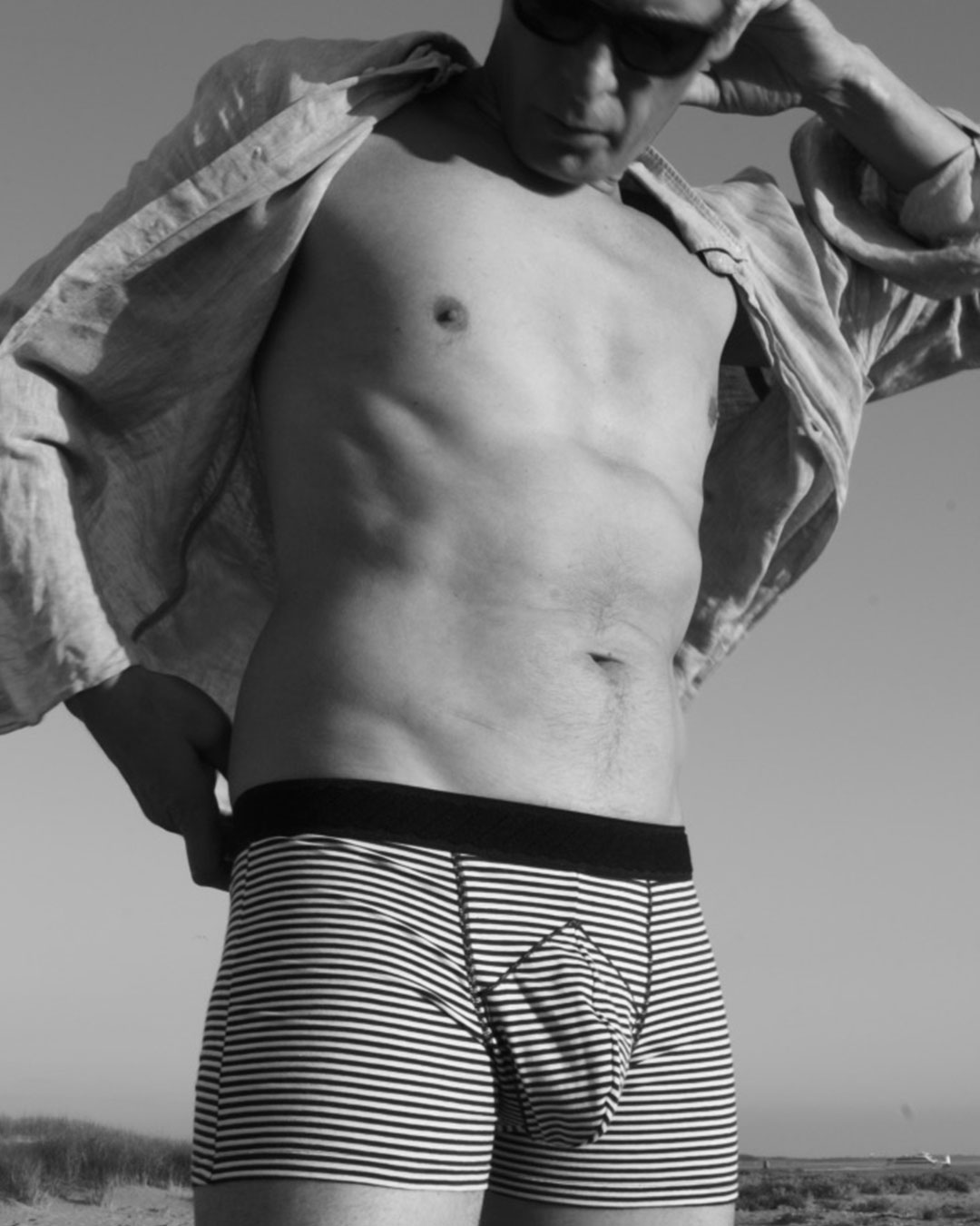 The inventor of the Sabords brief and boxer shorts poses during the putting on of men's underwear with an opening for the penis to pass through to the outside, with a protective flap on top.